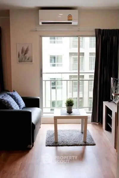 Modern living room with balcony view, stylish decor, and natural light.