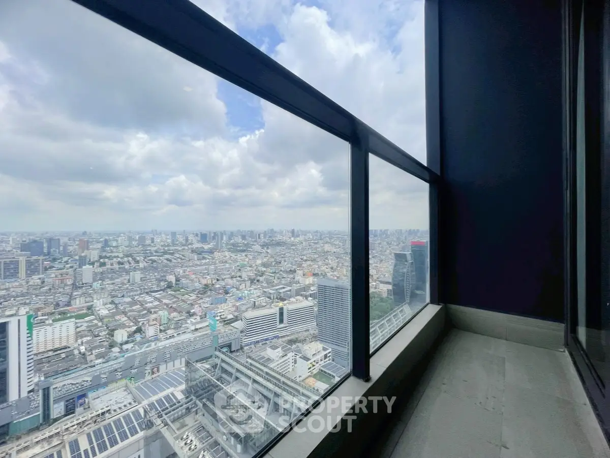 Stunning cityscape view from high-rise balcony with expansive windows