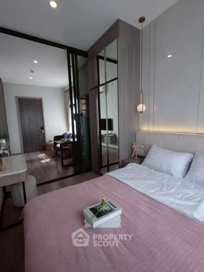 Modern bedroom with stylish decor and open view to living area