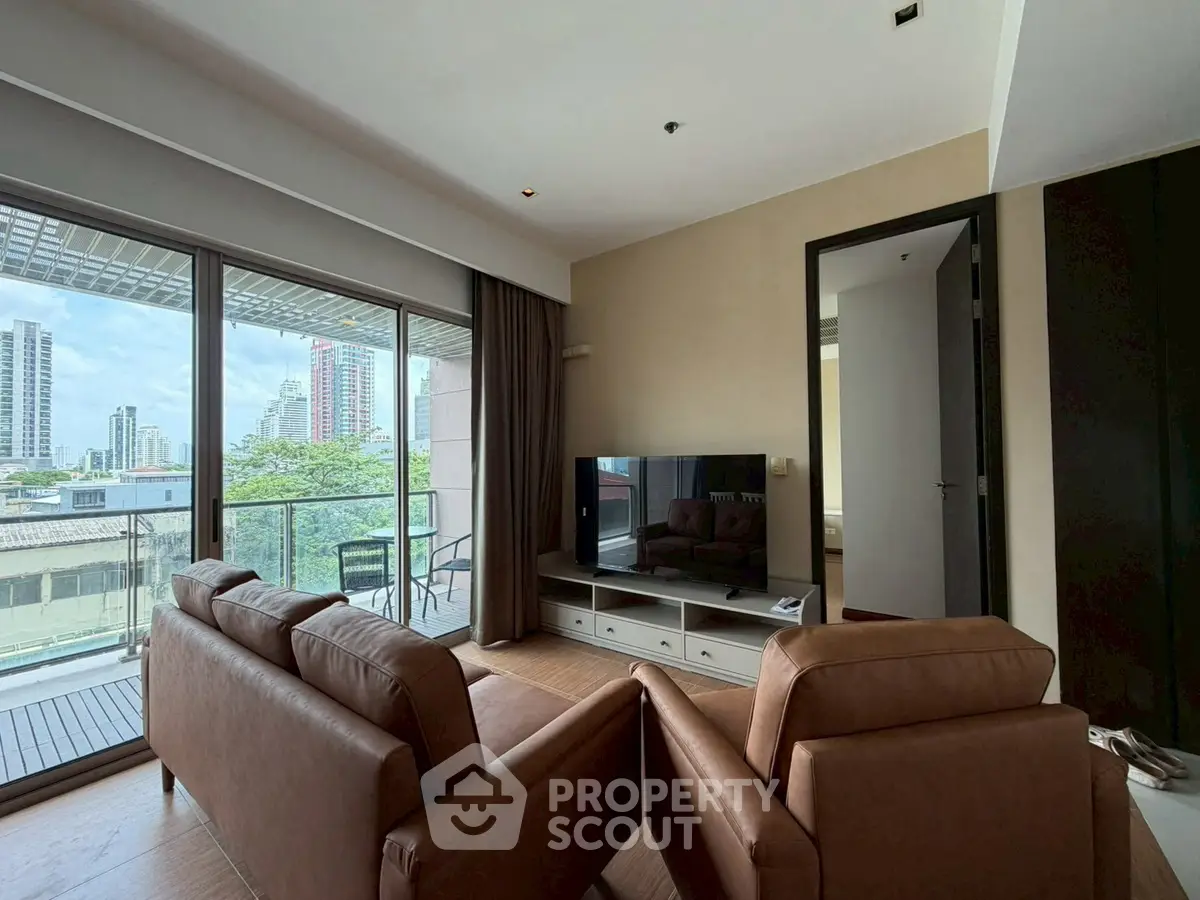 Spacious living room with modern furniture and city view balcony in luxury apartment.