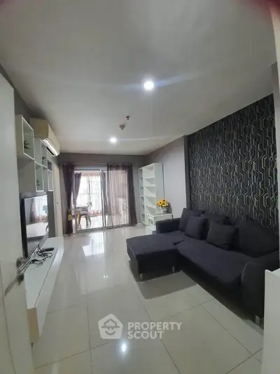 Spacious modern living room with sleek design and large windows for natural light.