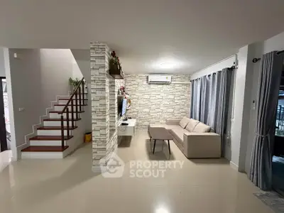 Modern living room with stylish stone accent wall and cozy sofa