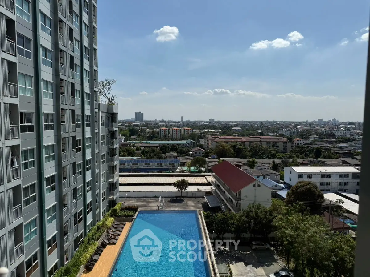Stunning cityscape view from high-rise with luxurious pool and modern architecture.