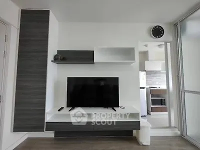 Modern living room with sleek TV unit and open kitchen view