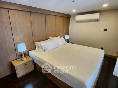 Modern bedroom with wooden accents and air conditioning unit