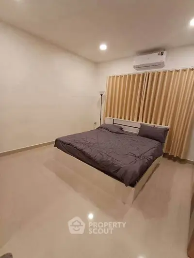 Spacious bedroom with modern decor and air conditioning