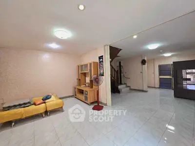 Spacious living area with modern decor and ample natural light