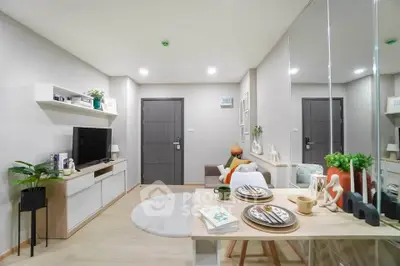 Modern living room with stylish decor and dining area in a cozy apartment.