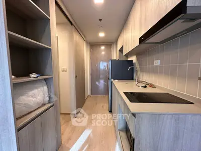 Modern kitchen with sleek cabinetry and built-in appliances in a stylish apartment.