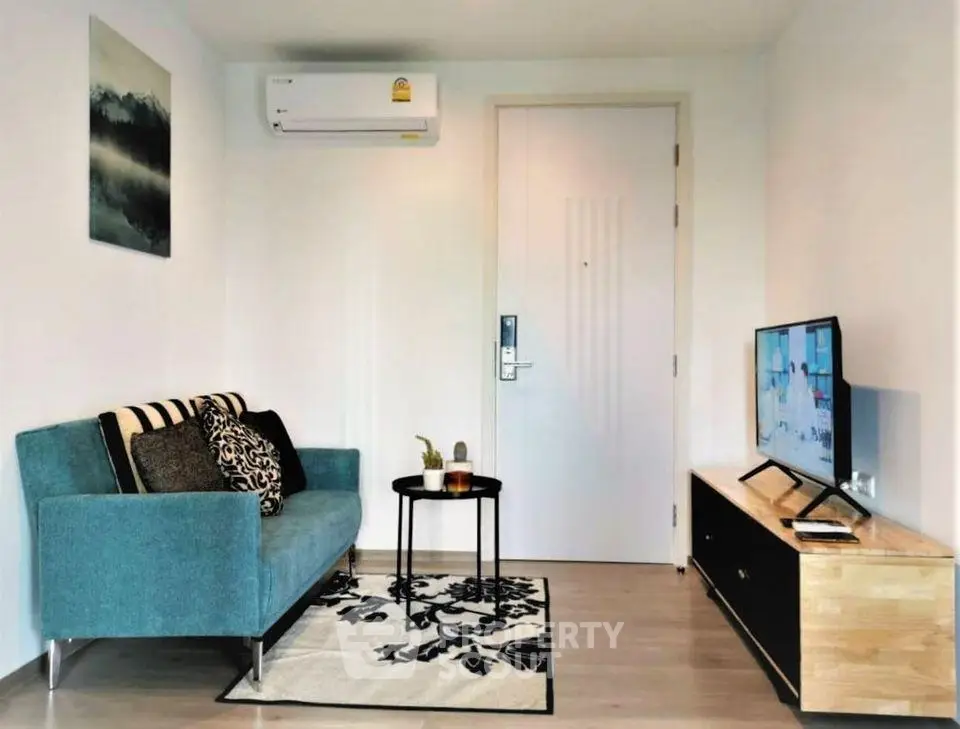 Modern living room with stylish sofa, wall-mounted TV, and air conditioning in a cozy apartment.