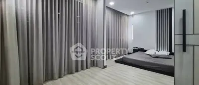 Modern minimalist bedroom with floor-to-ceiling curtains and sleek design.