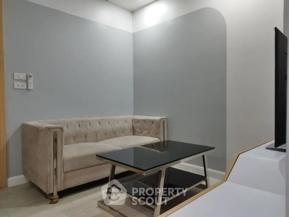 Modern living room with elegant sofa and sleek glass coffee table