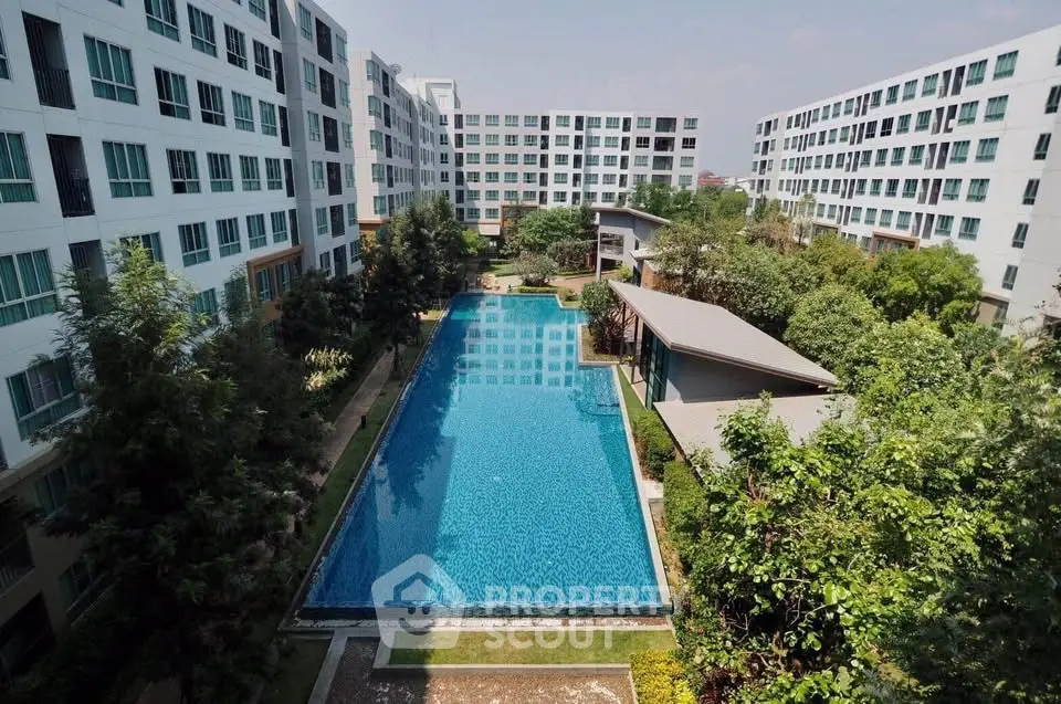 Luxurious apartment complex with stunning pool and lush greenery