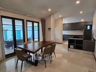 Modern open-plan kitchen and dining area with sleek design and ample natural light.