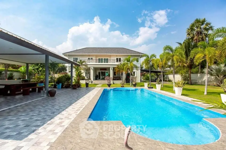 Luxurious villa with stunning pool and lush garden, perfect for relaxation and entertainment.
