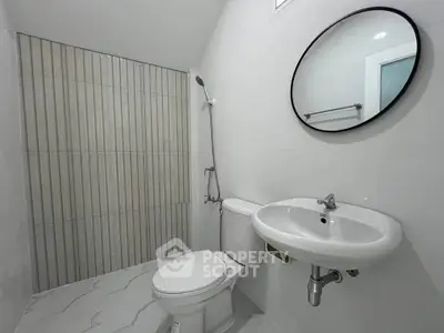 Modern minimalist bathroom with sleek fixtures and stylish tile design.