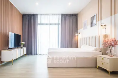 Spacious modern bedroom with elegant decor and natural light