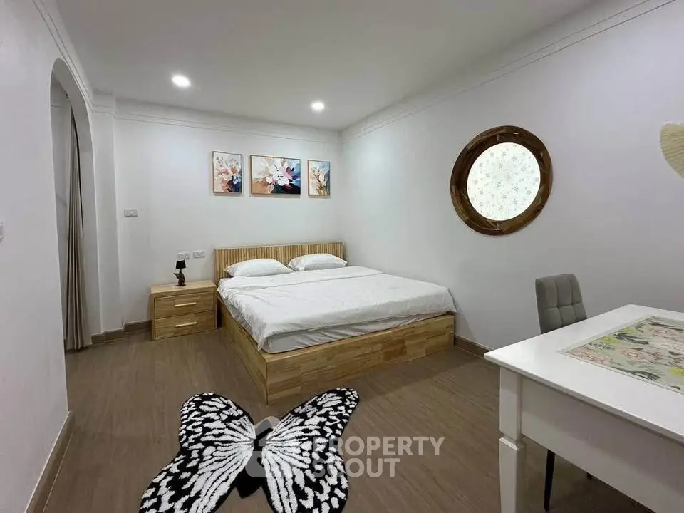 Charming bedroom with modern decor and unique butterfly rug