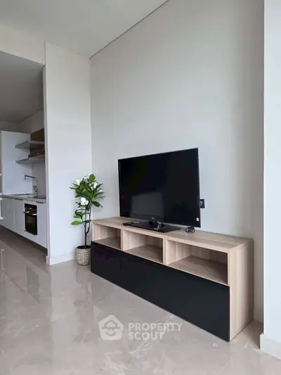 Modern living room with sleek TV stand and open kitchen layout