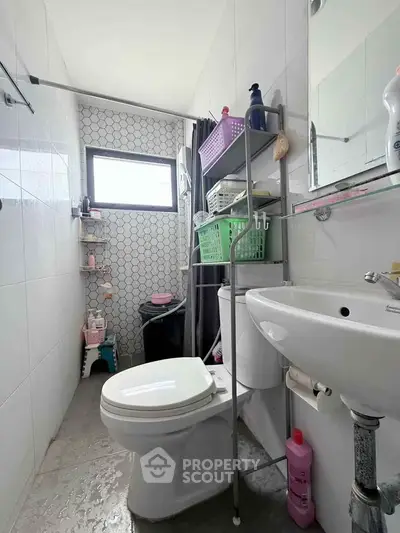 Compact bathroom with modern fixtures and natural light