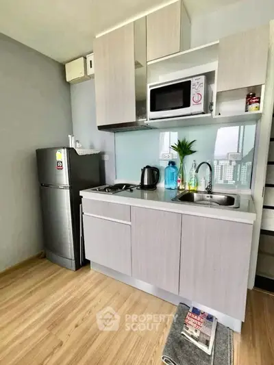 Modern compact kitchen with sleek cabinets and stainless steel appliances