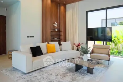 Modern living room with elegant decor, large sofa, and natural light from floor-to-ceiling windows.