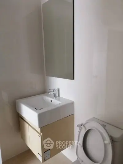 Modern minimalist bathroom with sleek sink and toilet
