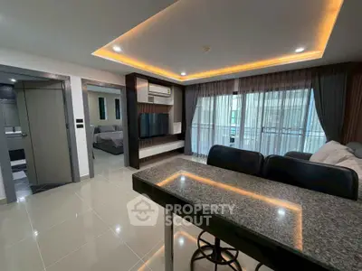 Modern open-plan living room with sleek design and ambient lighting in a stylish apartment.