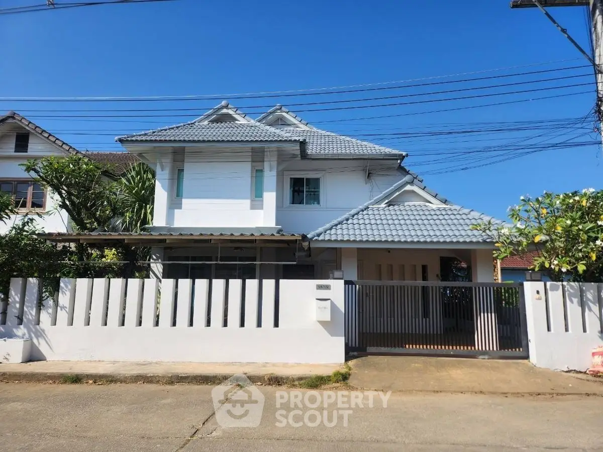 Charming two-story house with modern design and spacious front yard in a serene neighborhood.
