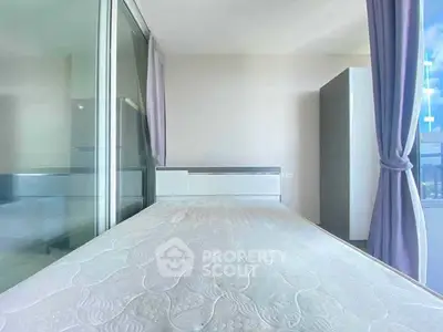 Modern bedroom with large window and purple curtains, featuring a sleek design and ample natural light.