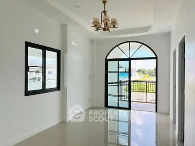 Bright and spacious living room with large window and modern chandelier