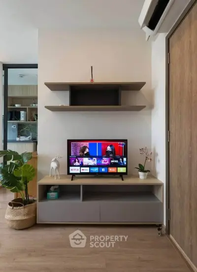 Modern living room with stylish TV unit and shelves, perfect for cozy entertainment nights.