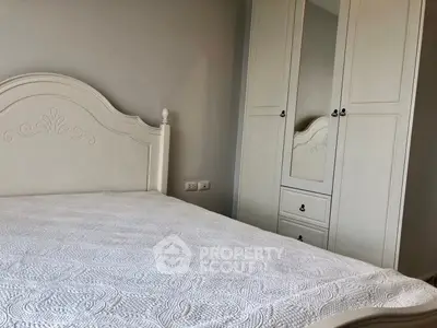 Elegant bedroom with classic white furniture and ornate bed frame