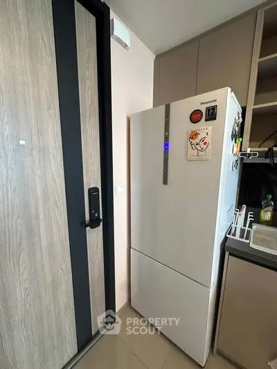 Modern kitchen with sleek refrigerator and stylish cabinetry