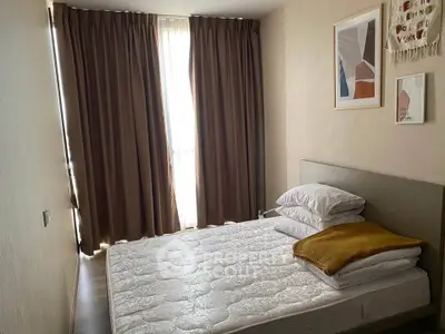Cozy bedroom with modern decor and natural light, perfect for relaxation.