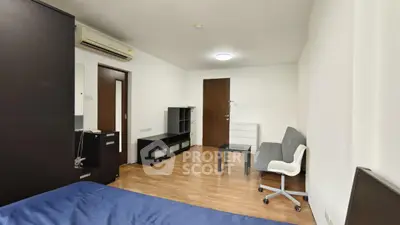 Modern bedroom with sleek furniture and wooden flooring