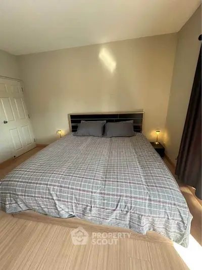 Cozy bedroom with modern decor and ample natural light