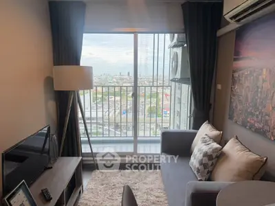 Modern living room with city view, cozy sofa, and stylish decor in high-rise apartment.