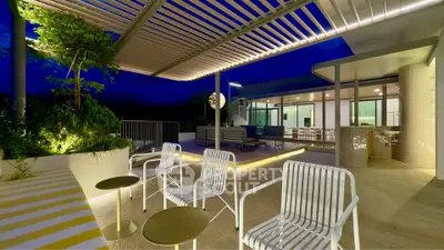 Luxurious rooftop terrace with modern seating and ambient lighting at night.