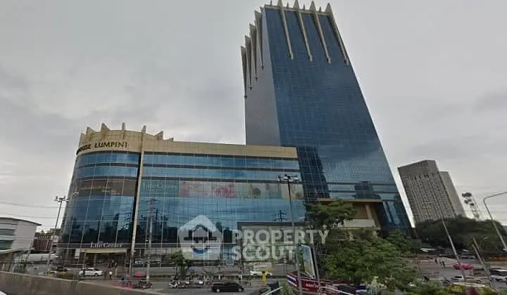 Stunning modern skyscraper with sleek glass facade in bustling city center.