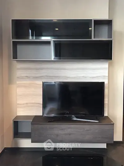 Modern living room with sleek TV unit and stylish wall-mounted shelves