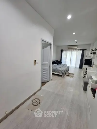 Modern bedroom with natural light and sleek design in a contemporary apartment.