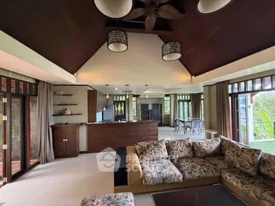 Spacious living room with high ceilings and open kitchen in luxury home