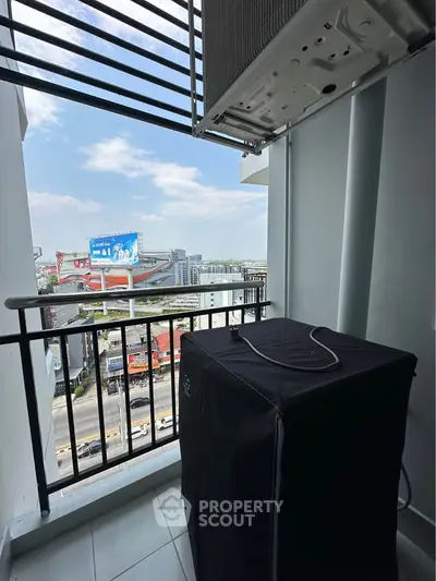 High-rise balcony with city view and air conditioning unit, perfect for urban living.