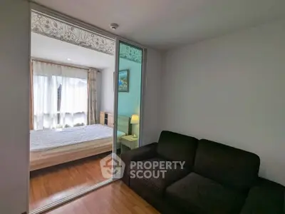Cozy bedroom with sliding glass doors and a comfortable sofa, perfect for relaxation.