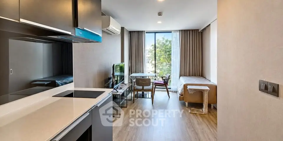 Modern studio apartment with open layout and large window view