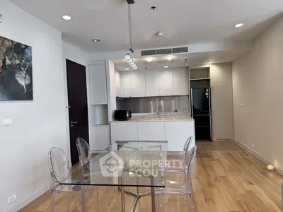 Modern kitchen with open layout and stylish dining area in a contemporary apartment.