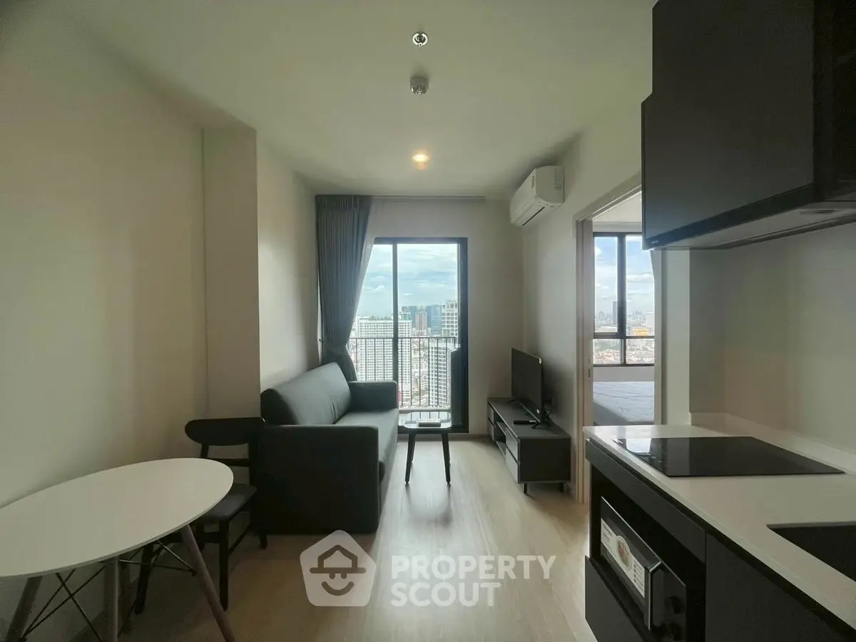 Modern apartment living room with city view and sleek kitchen