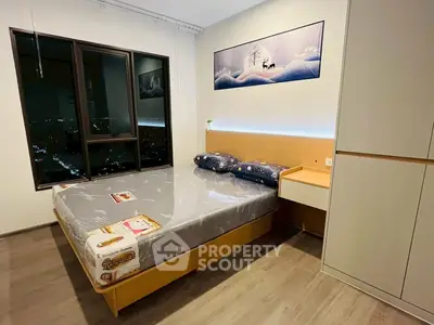 Modern bedroom with city view, stylish decor, and cozy ambiance.