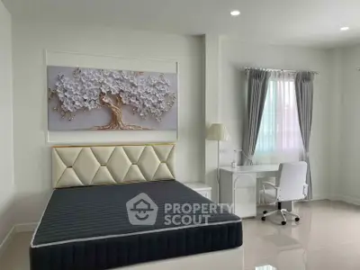 Modern bedroom with elegant decor and study area, featuring a stylish bed and desk setup.
